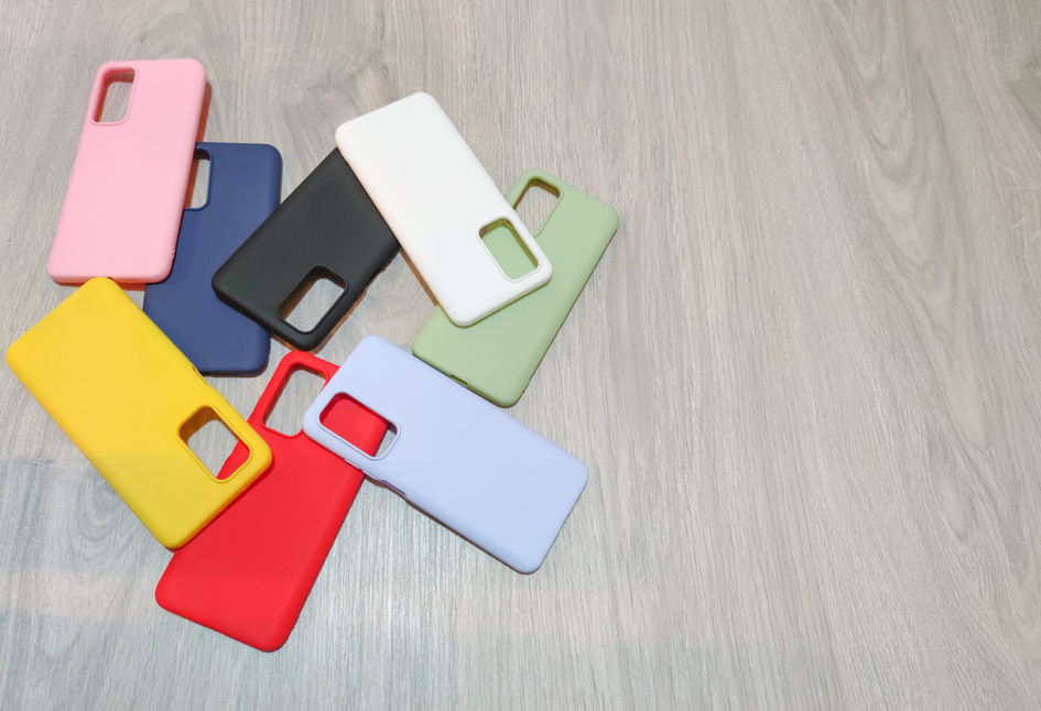 Colorful plastic back covers for mobile phones on wooden background. mobile phone protection. copy space